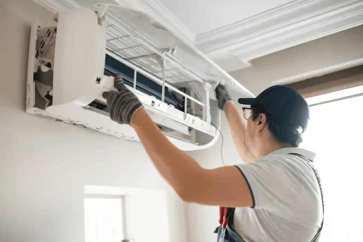 HVAC technician servicing an air conditioning unit